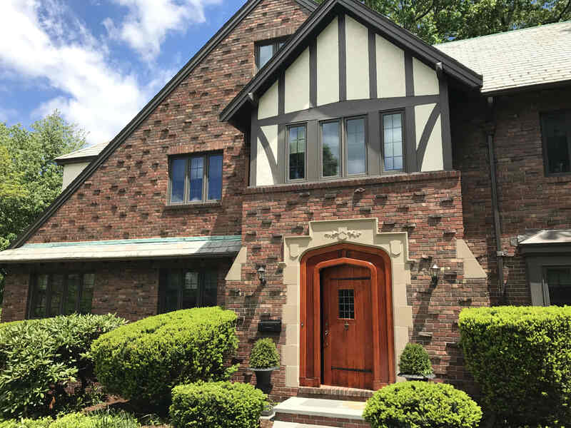 Stucco painting and stucco repairs on Tudor home in Newont, MA