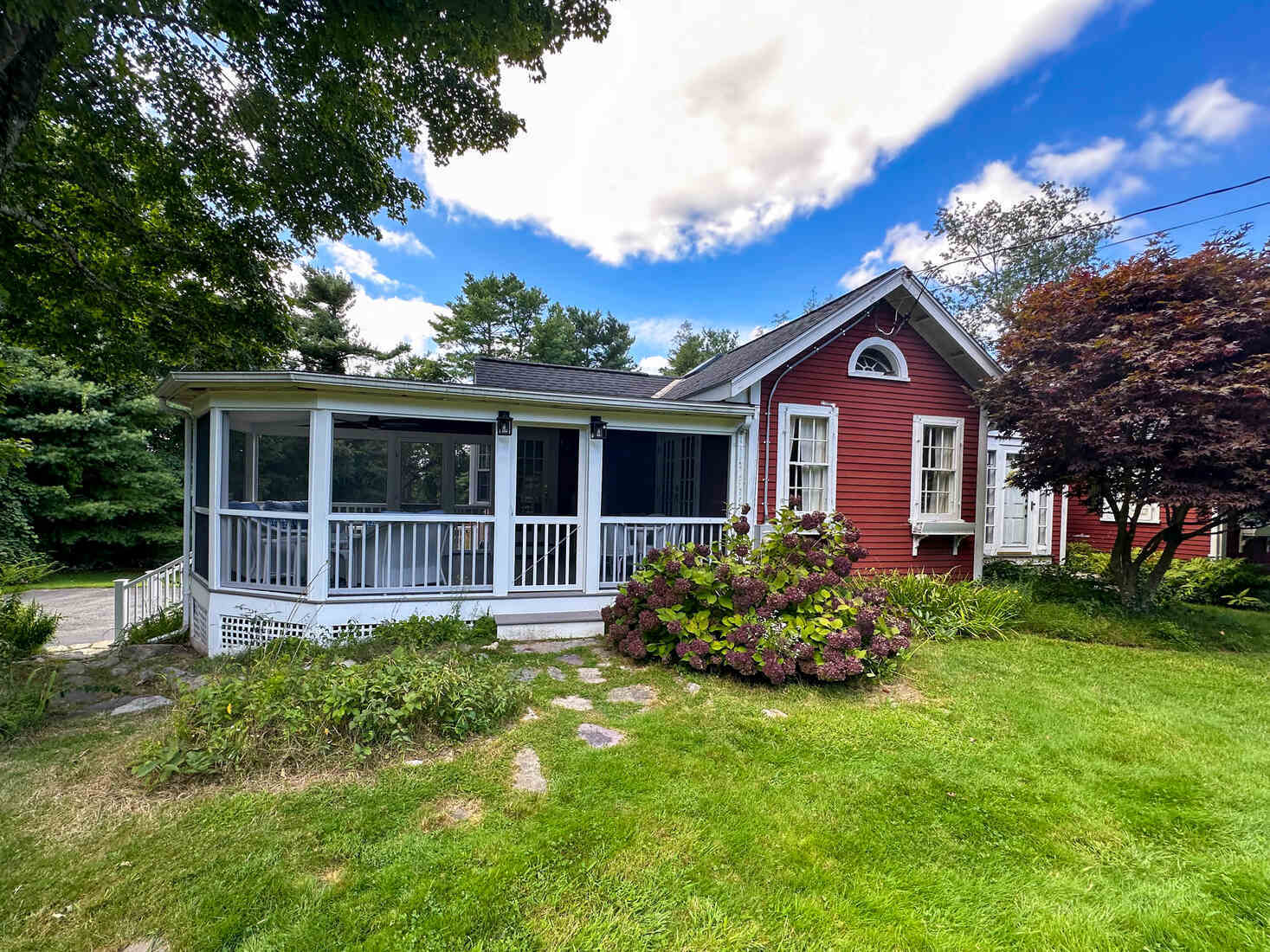 Aerial view of a stylish deck with a hot tub and seating area, part of a Medfield, MA renovation by Tom Curren