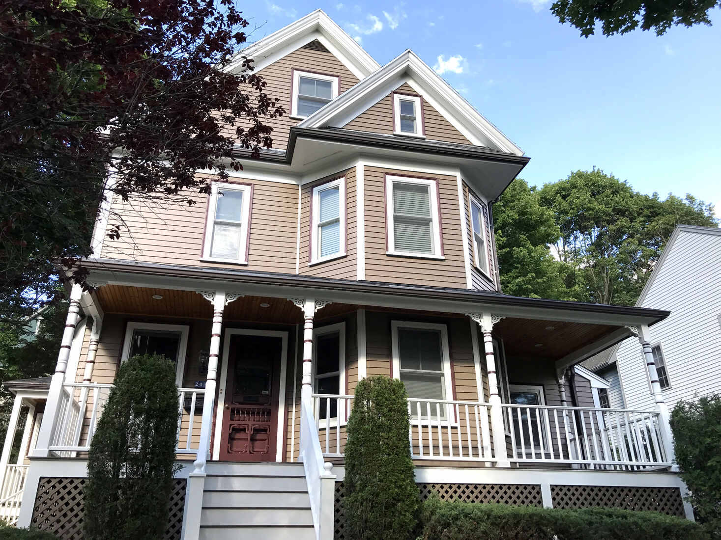 Beautifully painted Victorian home in Arlington, MA, showcasing expert exterior painting by Tom Curren Companies