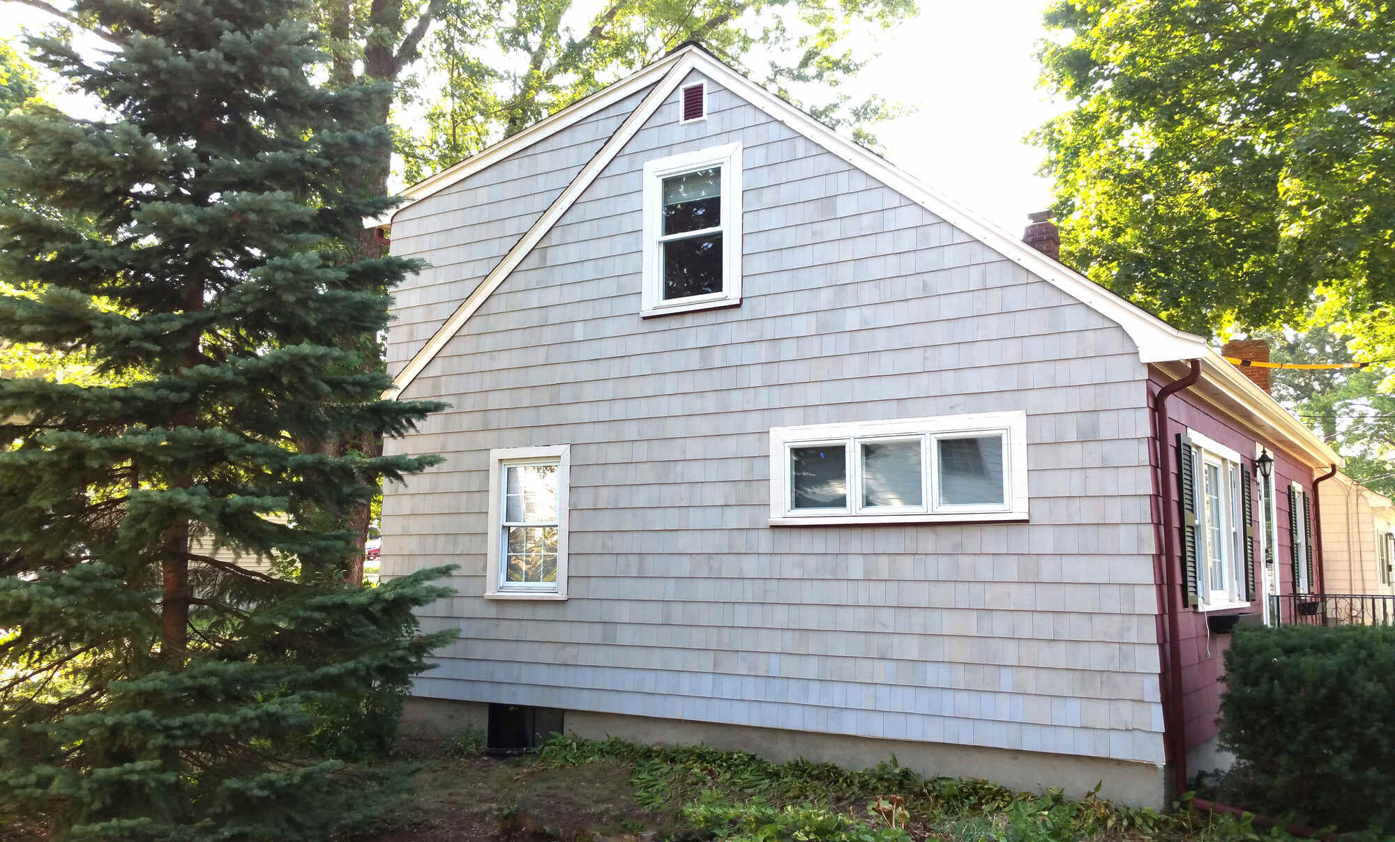 completed siding renovation showcasing a new wood shingles in Arlington, MA