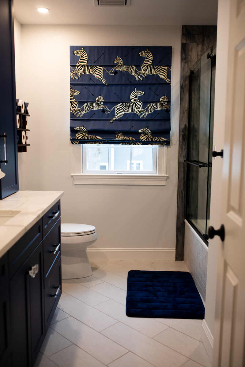 Small bathroom remodel with subway tile floors, black cabinets and black finishes