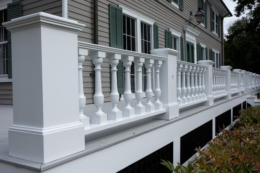 Professionally painted deck with white railing near Lincoln Massachusetts