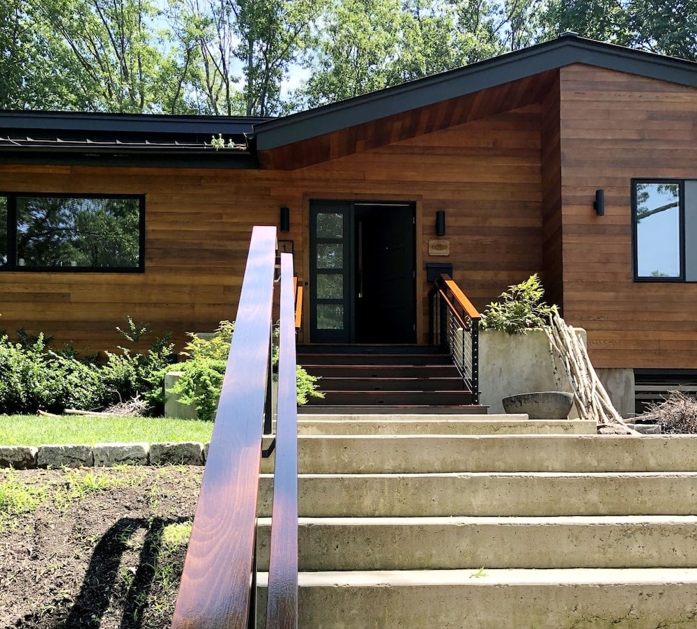 Exterior modern home with professional stained wood siding near Greater Boston