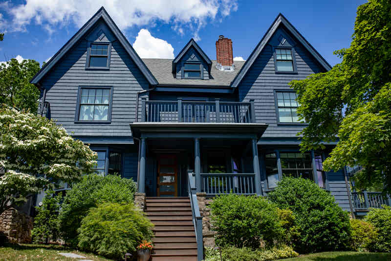 Massachusetts home with dark blue painted exterior siding
