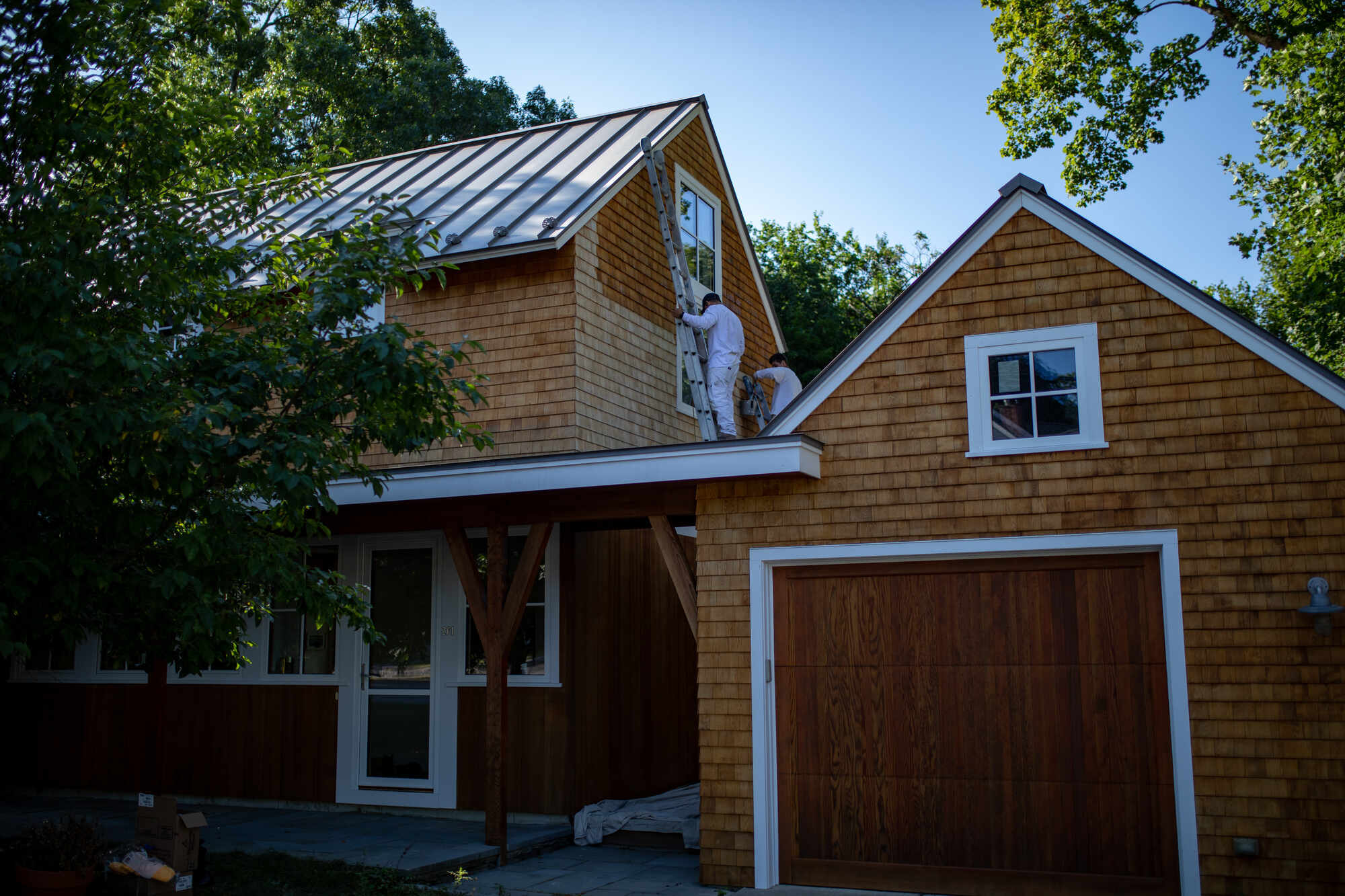 Exterior staining on a rustic-style home, completed by Tom Curren for a rich and durable wood finish