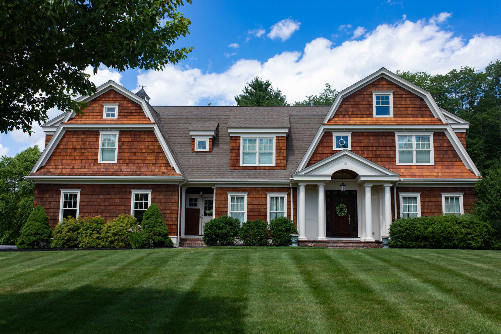 Stunning natural wood home exterior in Sudbury, MA, featuring fresh staining by Tom Curren