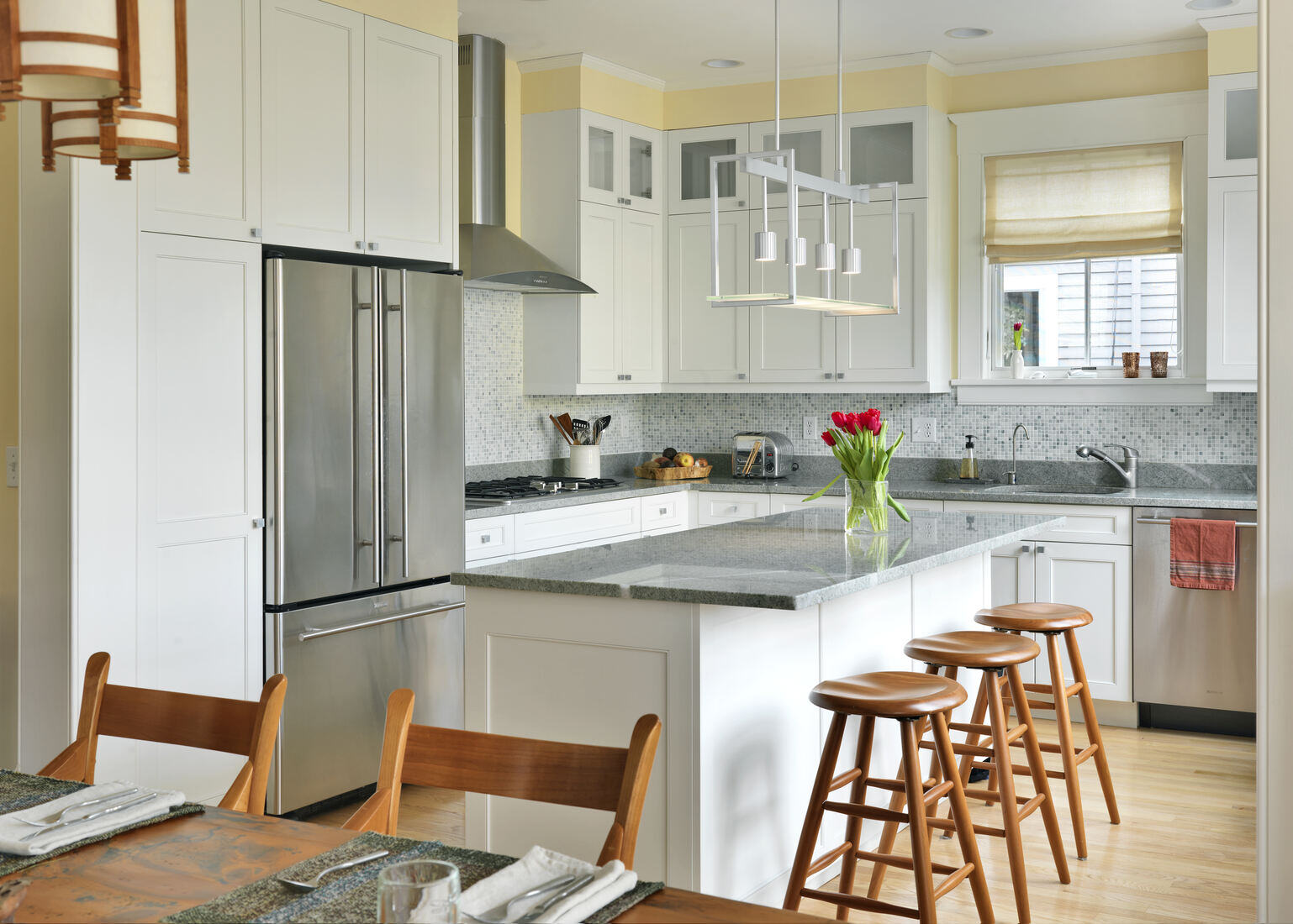 Custom kitchen remodel in Brookline, MA by Tom Curren, featuring a modern layout with quartz countertops and pendant lighting