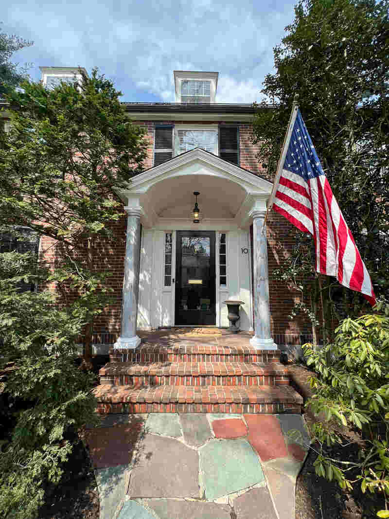 Exterior view of a front door with columns on both sides.